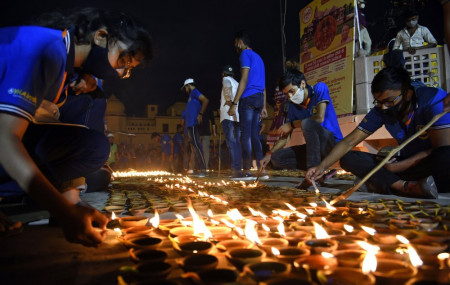 People light lamps on the banks of river Saryu in Ayodhya, India, Friday, Nov. 13, 2020.