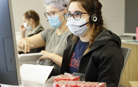 Employees schedule COVID-19 tests and prepare test kits at Primary Health Medical Group's clinic in Boise, Idaho, on Tuesday, Nov. 24, 2020.