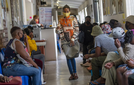 Volunteers wait to be checked at a vaccine trial facility for AstraZeneca at Soweto's Chris Sani Baragwanath Hospital outside Johannesburg, South Africa, Monday Nov. 30, 2020.