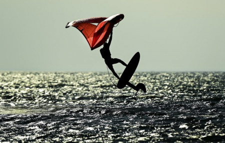 A wing-surfer catches some air on lake Ontario at Cherry Beach on a warm fall day during the COVID-19 pandemic in Toronto on Friday, Nov. 20, 2020.