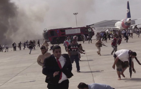 People run following an explosion at the airport in Aden, Yemen, shortly after a plane carrying the newly formed Cabinet landed on Wednesday, Dec. 30, 2020. No one on board the government pla