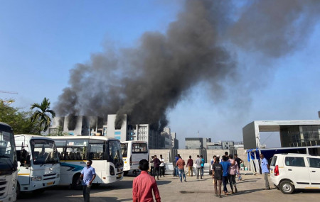 Smoke rises from the Serum Institute of India, the world's largest vaccine maker that is manufacturing the AstraZeneca/Oxford University vaccine for the coronavirus, in Pune, India, Thursday,