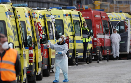 In this Jan. 22, 2021, file photo, more than a dozen ambulances queue waiting to hand over their COVID-19 patients to medics at the Santa Maria hospital in Lisbon.