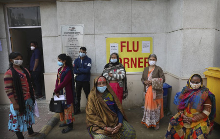 People wait outside a health center to get tested for COVID-19 in New Delhi, India, Thursday, Feb. 11, 2021.