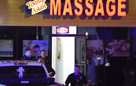 Authorities investigate a fatal shooting at a massage parlor, late Tuesday, March 16, 2021, in Acworth, Georgia.