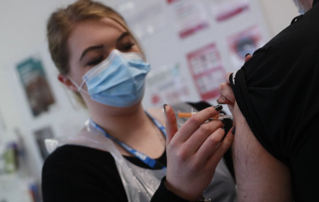 Pharmacy Technician Katrina Bonwick administers a dose of the AstraZeneca COVID-19 vaccine at the Wheatfield surgery in Luton, England, Thursday, March 18, 2021.