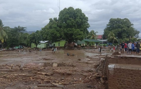 Residents inspect the damage at a village hit by flash flood in East Flores, Indonesia, Sunday, April 4, 2021.