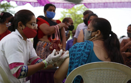 A health worker administers the COVISHIELD vaccine for COVID-19 at a residential area in Ahmedabad, India, Sunday, April 4, 2021.