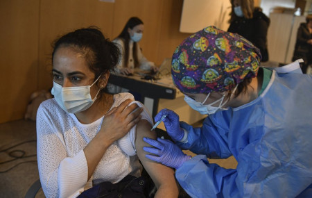 In this March 24, 2021 file photo, a woman receives a dose of the AstraZeneca COVID-19 vaccine, during a mass vaccination campaign at San Pedro Hospital, in Logrono, northern Spain.