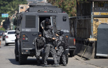 Police get out of an armored vehicle during an operation against alleged drug traffickers in the Jacarezinho favela of Rio de Janeiro, Brazil, Thursday, May 6, 2021.