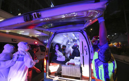 Rescue personnel help injured passengers at KLCC station after two light rail trains collided in a tunnel, injuring more than 200 people in Kuala Lumpur, Malaysia, Monday, May 24, 2021.