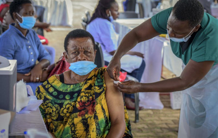 A woman receives a coronavirus vaccination at the Kololo airstrip in Kampala, Uganda, Monday, May 31, 2021.