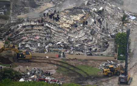 In this aerial image search and rescue workers work the site of an oceanfront condo building that partially collapsed, in Surfside, Florida, Friday, June 25, 2021.