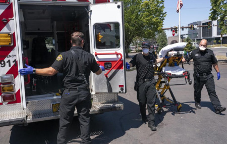 Salem Fire Department paramedics and employees of Falck Northwest ambulances respond to a heat exposure call during a heat wave, Saturday, June 26, 2021, in Salem, Oregon.