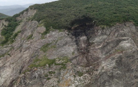 This photo released by the Russia Emergency Situations Ministry press service on Wednesday, July 7, 2021, shows wreckage of a missing Antonov An-26 missing plane found near its destination ai