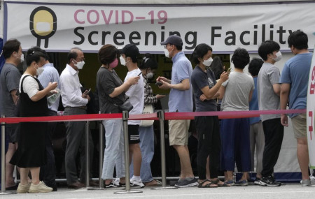 People queue in line to wait for the coronavirus testing at a Public Health Center in Seoul, South Korea, Friday, July 9, 2021.