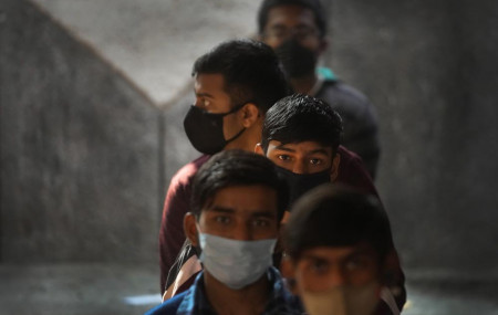 Children wait to receive their vaccination for COVID-19 at a government school in New Delhi, India, Monday, Jan. 3, 2022. Indian health authorities Monday began vaccinating teens in the age g