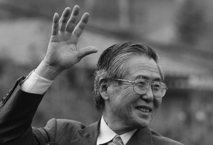 FILE - Peru's former president Alberto Fujimori waves at his home in Santiago after leaving the academy for the training of corrections officers in Santiago, Chile, May 18, 2006. (AP Photo)