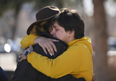 Leia-jhene Seals, left, hugs Carter Rodriguez outside All Souls Unitarian Church before a vigil for the victims of an overnight fatal shooting at Club Q, an LGBTQ nightclub, Sunday, Nov. 20, 2022, in Colorado Springs, Colorado. AP/RSS Photo