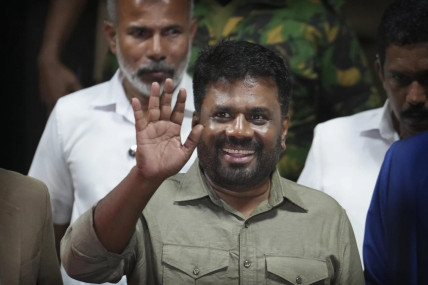 Marxist lawmaker Anura Kumara Dissanayake waves as he arrives at the election commission office after winning Sri Lankan presidential election, in Colombo, Sri Lanka, Sunday, Sept. 22, 2024. (AP Photo)