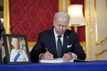 President Joe Biden signs a book of condolence at Lancaster House in London, following the death of Queen Elizabeth II, Sunday, Sept. 18, 2022. AP/RSS Photo