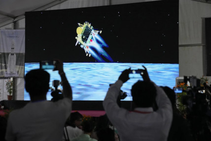 Journalists film the live telecast of spacecraft Chandrayaan-3 landing on the moon at ISRO's Telemetry, Tracking and Command Network facility in Bengaluru, India, Wednesday, Aug 23, 2023. (AP/RSS)