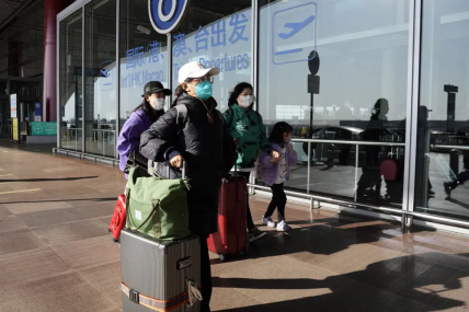 FILE - Passengers wearing masks walk through the Capital airport terminal in Beijing on Dec. 13, 2022. AP/RSS Photo