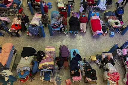 People look after their elderly relatives lying on stretchers and receiving intravenous drips while using ventilators at the Changhai Hospital hall in Shanghai, China, Tuesday, Jan. 3, 2023. AP/RSS Photo