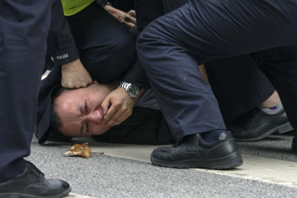 In this photo taken on Sunday, Nov. 27, 2022, policemen pin down and arrest a protester during a protest on a street in Shanghai, China. AP/RSS Photo