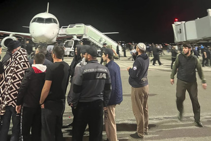 People in the crowd walk shouting antisemitic slogans at an airfield of the airport in Makhachkala, Russia, Monday, Oct. 30, 2023. (AP/RSS Photo)