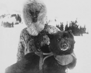 FILE - Gunnar Kaasen and with his dog Balto, the heroic dogsled team leader, sit for a portrait in the early 1920s. As a part of the Zoonomia Project, with 11 papers published Thursday, April 27, 2023, in the journal Science, by comparing Balto’s genes to those of other dogs, researchers found he was more genetically diverse than modern breeds and may have carried genetic variants that helped him survive harsh conditions.  AP/RSS Photo
