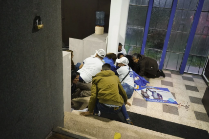 Supporters take cover after the presidential candidate was shot. AP/RSS Photo