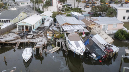 This aerial drone view shows damaged homes and a vehicle collapsed into water after storm surge from Hurricane Helene, Saturday, Sept. 28, 2024, in Madeira Beach, Fla. (AP)