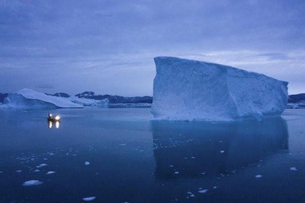FILE - A boat navigates at night next to large icebergs in eastern Greenland on Aug. 15, 2019. AP/RSS Photo