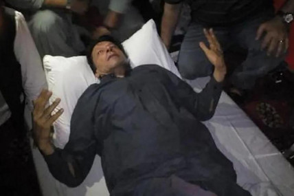 In this photo released by former Pakistani Prime Minister Imran Khan's party, Pakistan Tehreek-e-Insaf, Imran Khan, who injured in a shooting incident, is seen after the incident, in in Wazirabad, Pakistan, Thursday, Nov. 3, 2022.  AP/RSS Photo