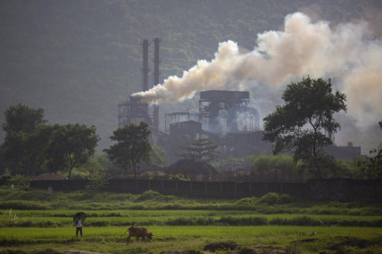 FILE- Smoke rises from a coal-powered steel plant at Hehal village near Ranchi, India, in eastern state of Jharkhand, Sept. 26, 2021.  AP/RSS Photo
