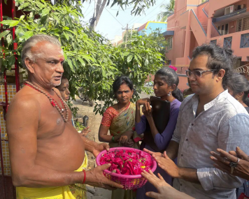 Arjun Viswanathan places his hands on a basket of flowers to be offered to the Hindu deity Ganesh at the Sri Lakshmi Visa Ganapathy Temple on Nov. 28, 2022, in Chennai, a city on the southern coast of India. AP/RSS Photo