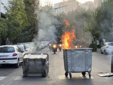 In this Tuesday, Sept. 20, 2022, photo taken by an individual not employed by the Associated Press and obtained by the AP outside Iran, a trash bin is burning as anti-riot police arrive during a protest over the death of a young woman who had been detained for violating the country's conservative dress code, in downtown Tehran, Iran. AP/RSS Photo