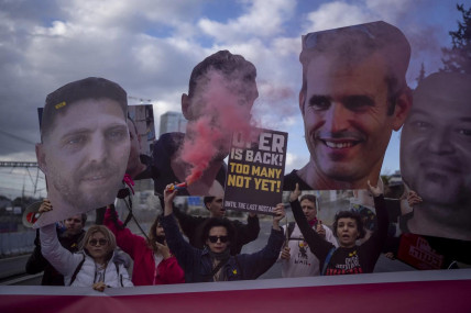 Relatives and supporters of Israelis held hostage in the Gaza Strip, hold photos depicting their faces during a protest demanding their release from Hamas captivity, in Tel Aviv, Israel, Thursday, Feb. 13, 2025. (AP Photo)