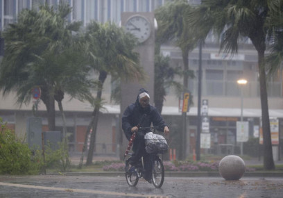 A man on a bicycle makes his way through the rain in Miyazaki, southern Japan, Sunday, Sept 18, 2022, as a powerful typhoon approaching southern Japan on Sunday lashed the region with strong winds and heavy rain. (AP/RSS Photo)