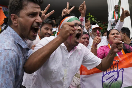 Supporters of opposition Congress party celebrate early leads for the party in the Karnataka state elections in Bengaluru, India, Saturday, May 13, 2023. AP/RSS Photo