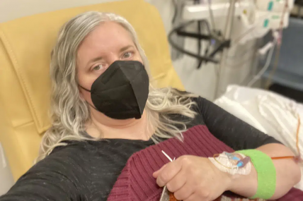 This photo provided by Amy Watson of Portland, Ore., shows her during  an iron infusion in December 2022. AP/RSS Photo