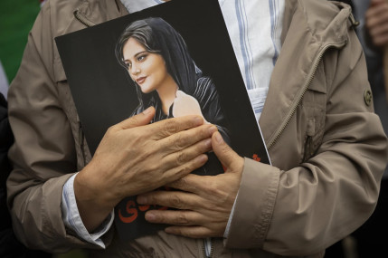 A portrait of Mahsa Amini is held during a rally calling for regime change in Iran following the death of Amini, a young woman who died after being arrested in Tehran by Iran’s notorious “morality police”, in Washington, on Oct. 1, 2022. (AP/RSS Photo)