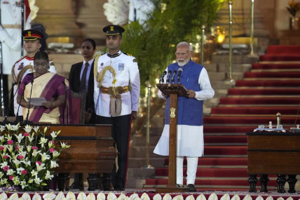 Narendra Modi, right, is sworn-in as the Prime Minister of India by President Draupadi Murmu, left, at the Rashtrapati Bhawan, in New Delhi, India, Sunday, June 9, 2024. (AP Photo)