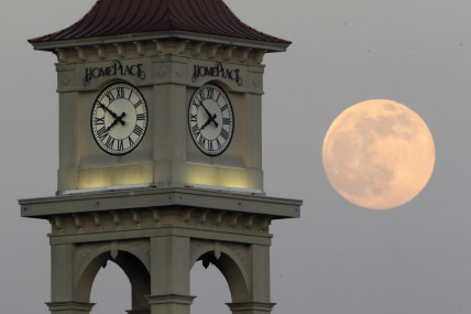 FILE - The moon rises behind the Home Place clock tower in Prattville, Ala., Saturday, June 22, 2013. NASA wants to come up with an out-of-this-world way to keep track of time, putting the moon on its own souped-up clock. The White House on Tuesday, April 2, 2204, told NASA to work with other agencies abroad to come up with a new moon-centric time reference system.  AP/RSS Photo