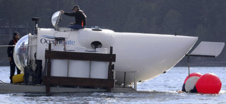 FILE - OceanGate CEO Stockton Rush emerges from the hatch atop the OceanGate submarine Cyclops 1 in the San Juan Islands, Washington, on Sept. 12, 2018.