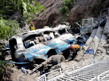 Rescue workers look for the victims and wounded passengers from the wreckage of a bus that fell into a ravine, near Kahuta, Pakistan, Sunday, Aug. 25, 2024. (AP Photo)