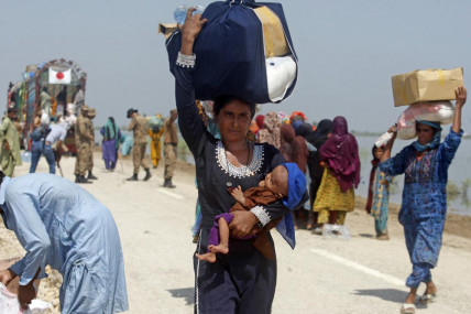 Victims of regional flooding from monsoon rains receive relief aid from the Pakistani Army in the Qambar Shahdadkot district of Sindh Province, Pakistan, Sept. 9, 2022. AP/RSS Photo