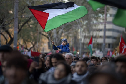 FILE - A boy waves a Palestinian flag as demonstrators march during a protest in support of Palestinians and calling for an immediate ceasefire in Gaza, in Barcelona, Spain, on Jan. 20, 2024. AP/RSS Photo