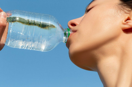 (Girl drinks water from a plastic bottle by Wuestenigel is available at https://bit.ly/3H0F7PH)